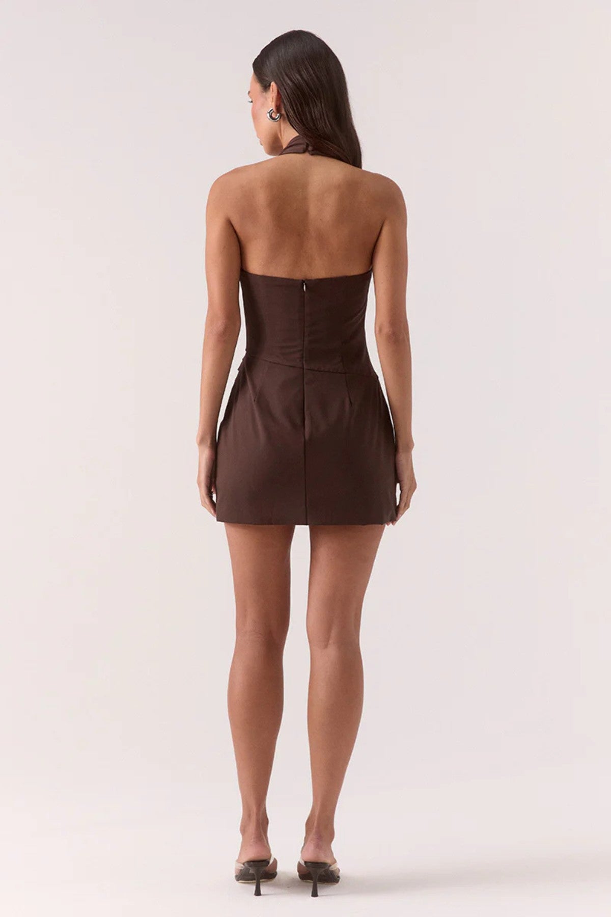 Darcie Skortsuit Ganache by Sovere, a fitted halter skortsuit with wrap skirt and asymmetric waist for chic day-to-night styling.