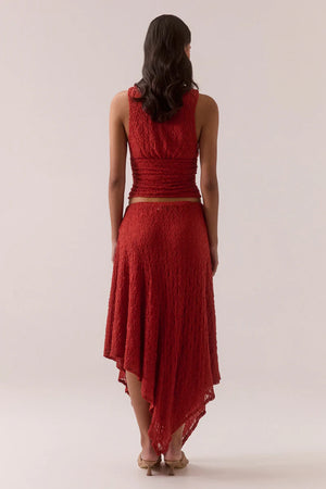 Aaila Lace Skirt – Blood Orange by Sovere, stretch lace midi with asymmetric hem and removable lining. Perfect for elevated looks.