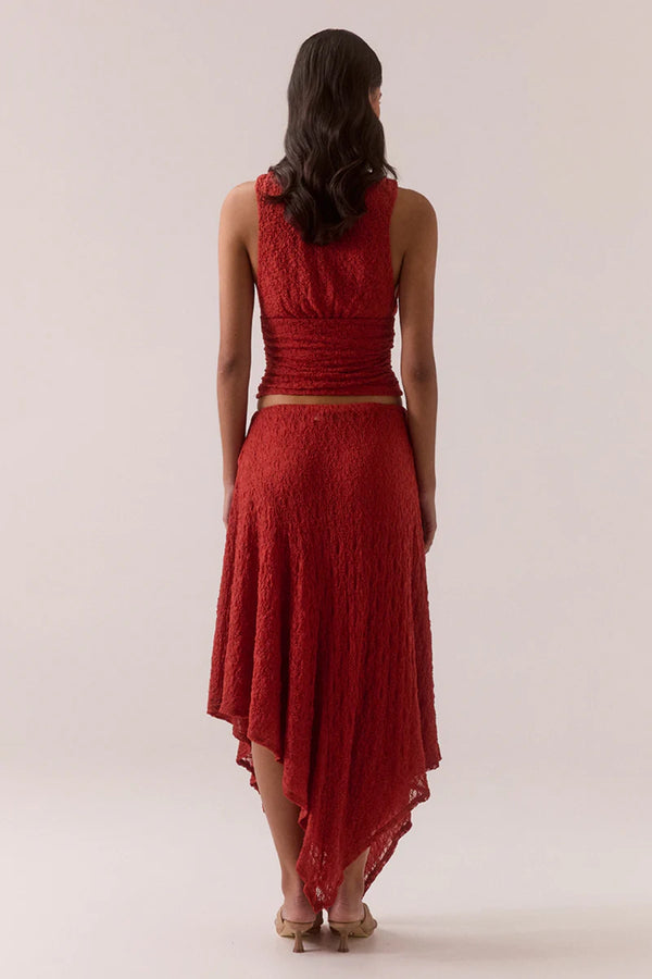 Aaila Lace Skirt – Blood Orange by Sovere, stretch lace midi with asymmetric hem and removable lining. Perfect for elevated looks.