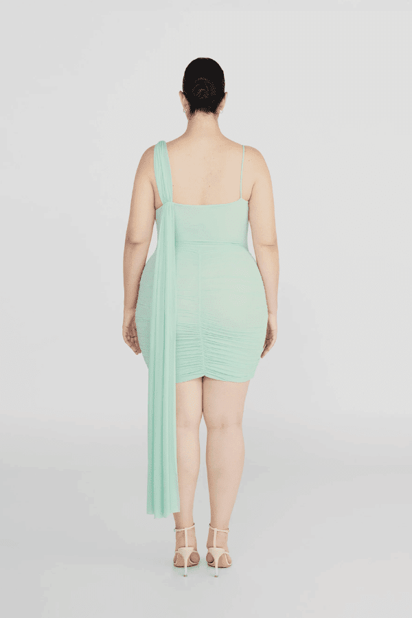 Hilván Mini Dress Salvia by Maygel Coronel – A trendy, sculptural mini with asymmetric neckline, 3D floral strap, ruched bodice, and flowing back sash. Perfect for modern, elegant nights out.