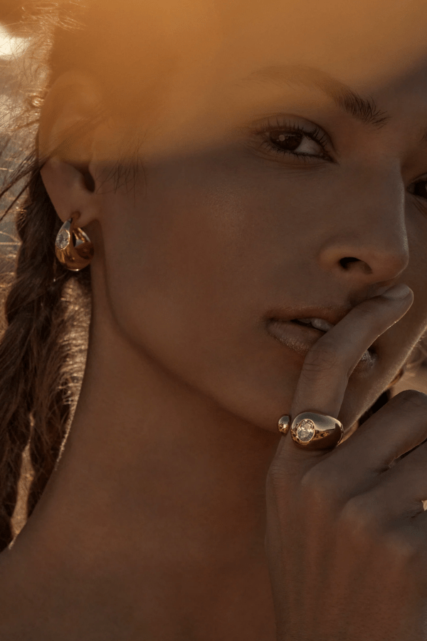 Vesper Ring Gold by Amber Sceats, sculptural curved design with sparkling cubic zirconia, handcrafted in Italy for a chic, viral statement piece.