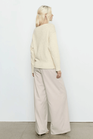 Allure Sweater Soft Yellow by Sovere Studio – Soft, breathable 100% cotton knit with wide 'V' neckline, dropped shoulders, long sleeves, and ribbed finish. Relaxed fit, perfect for layering.