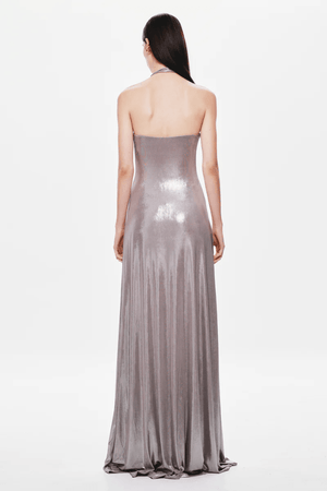 Jennifer Foil Jersey Dress Cinder by Misha – Trendy slim-fit maxi with deep V halter neckline, gathered waist, and cascading sash, perfect for glamorous day-to-evening occasions.