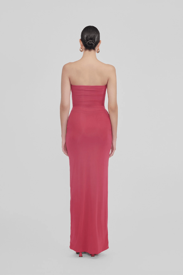 Campano Crimson by Maygel Coronel – A sleek strapless column dress with front twist draping and signature 3D floral detail, perfect for sophisticated evening events.