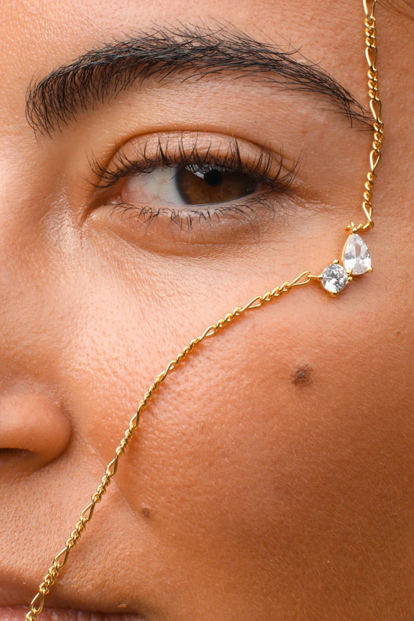 Twin Flame Necklace by Avant Studio in 18k gold plated sterling silver with cubic zirconia and adjustable chain.