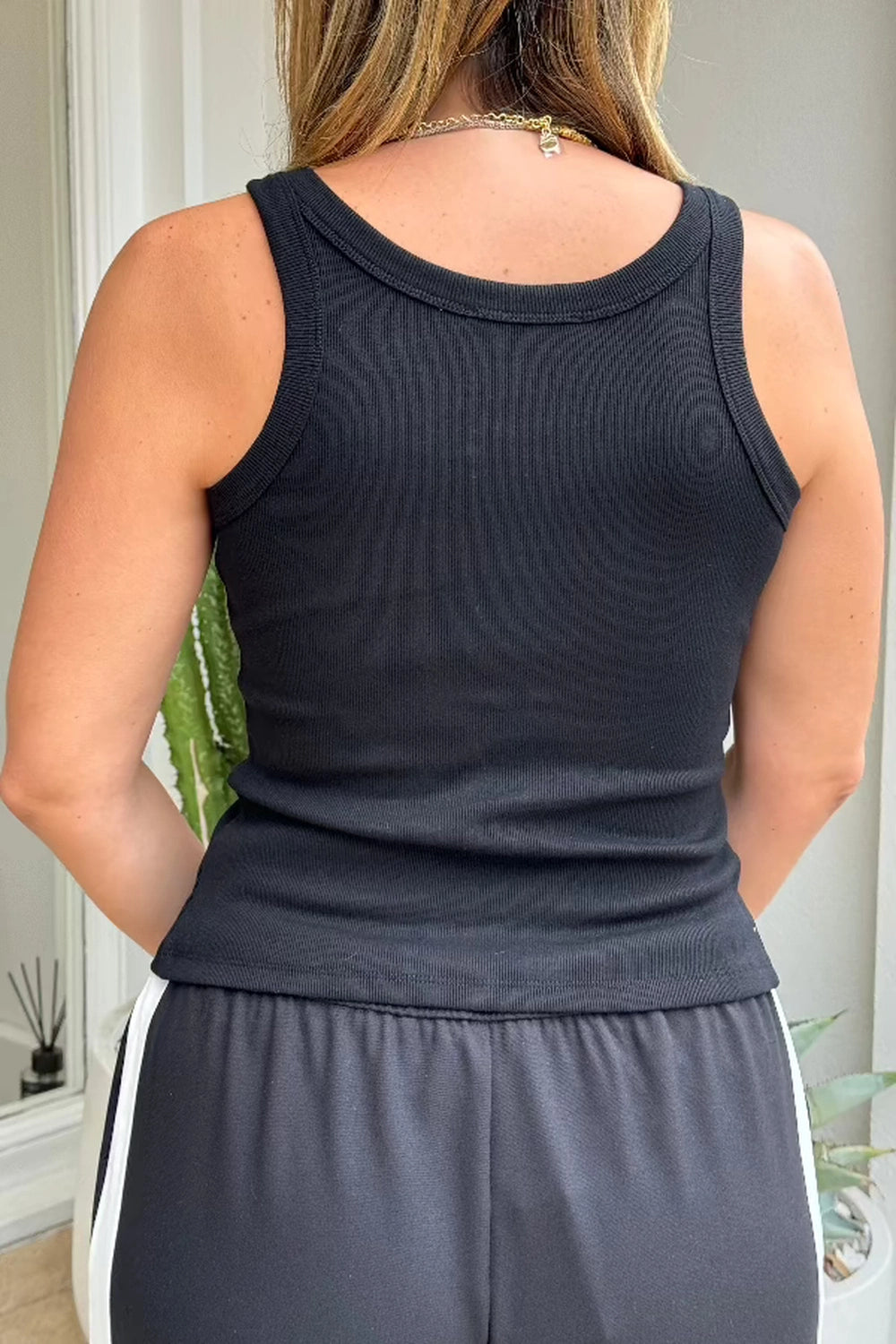 Frankie Scoop Tank White by Sneaky Link – A trendy, versatile cotton blend tank with a chic snap button front and flattering scoop neckline. Perfect for casual summer days or dressed-up looks.