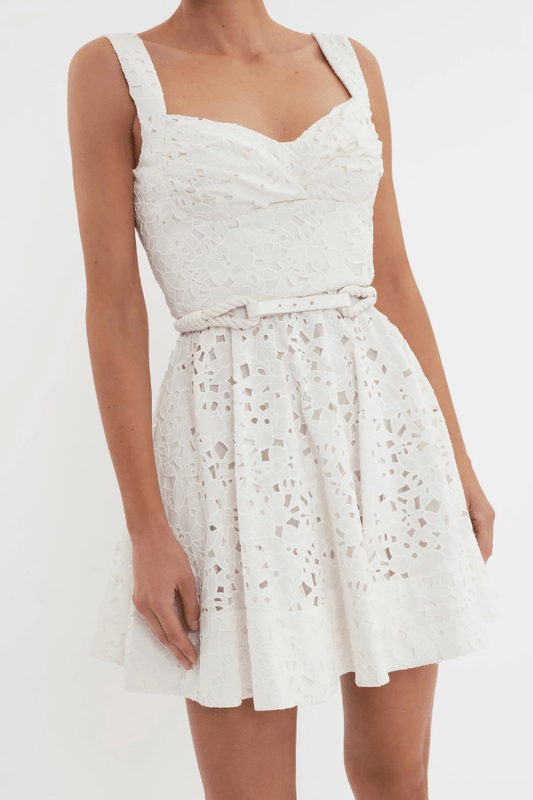 Nuvola Bustier Mini Dress Ivory by Rebecca Vallance – A chic broderie anglaise mini with sweetheart neckline, belted waist, and fitted bodice. Perfect for trendy daytime events or elegant summer parties.