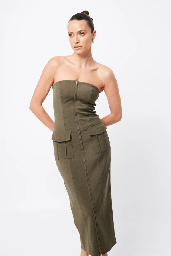 Low Profile Midi Dress Khaki by Mossman – A chic, strapless utility-inspired midi with exposed zip, front pockets, and back split, perfect for modern, versatile styling.