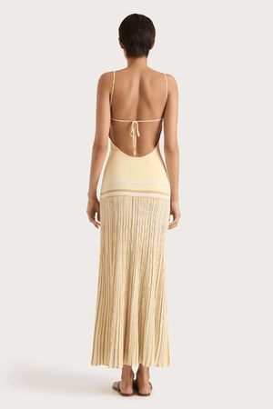 Citara Maxi Dress Butter Stripe by Faithfull the Brand – Trendy ribbed knit maxi with adjustable straps and backless tie, perfect for effortless summer elegance and beach days.