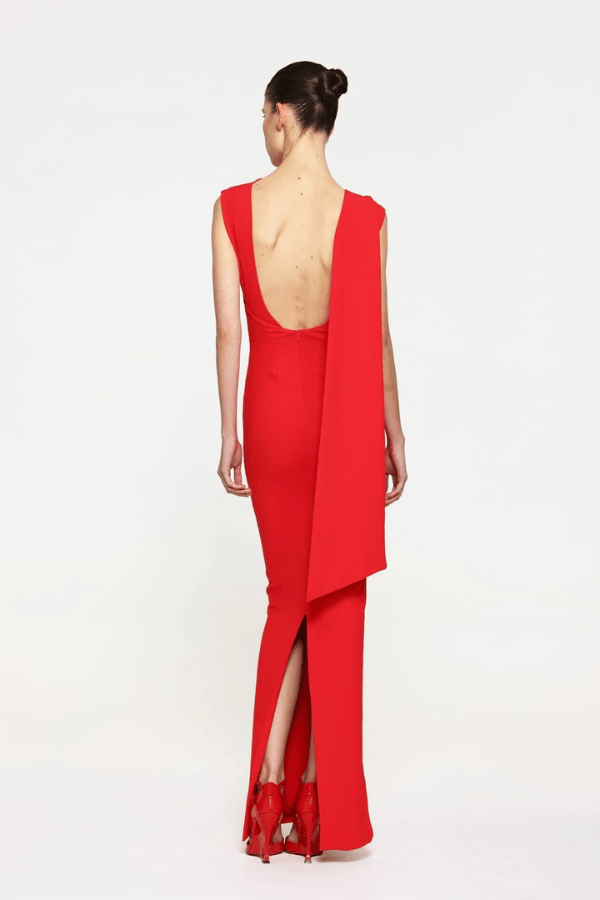 Audrey Gown Cherry Red by Effie Kats – A chic stretch crepe gown with a straight neckline, exaggerated low back, and elegant over-the-shoulder detail, perfect for special occasions.