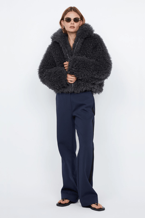 Argo Jacket Charcoal by Bec + Bridge – A chic charcoal faux fur bomber with wide collar, relaxed fit, front hook closure, and low waist finish. Fully lined. Dry clean only.