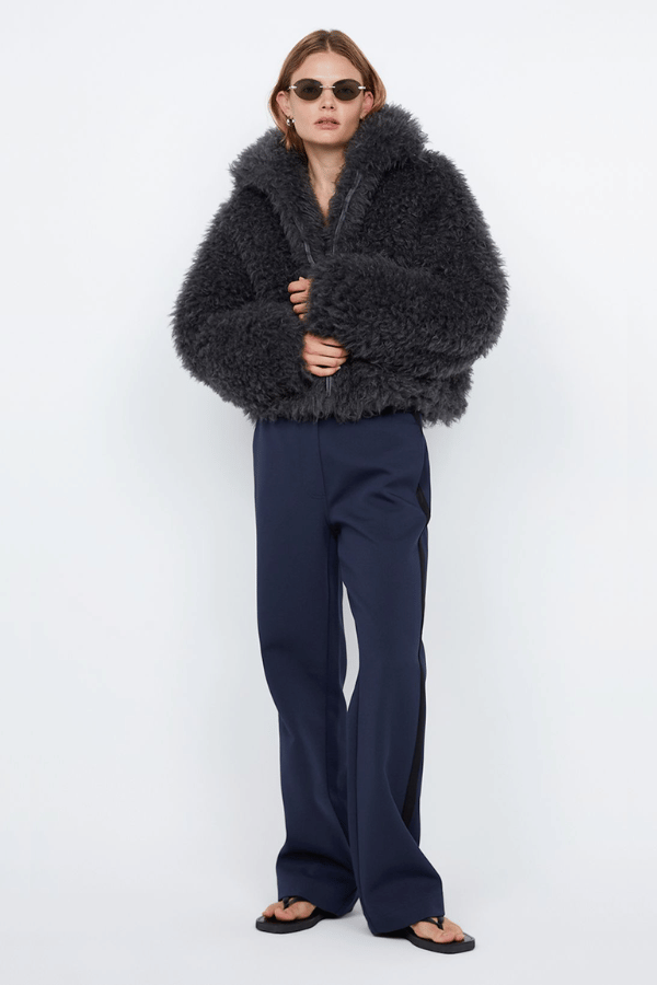 Argo Jacket Charcoal by Bec + Bridge – A chic charcoal faux fur bomber with wide collar, relaxed fit, front hook closure, and low waist finish. Fully lined. Dry clean only.