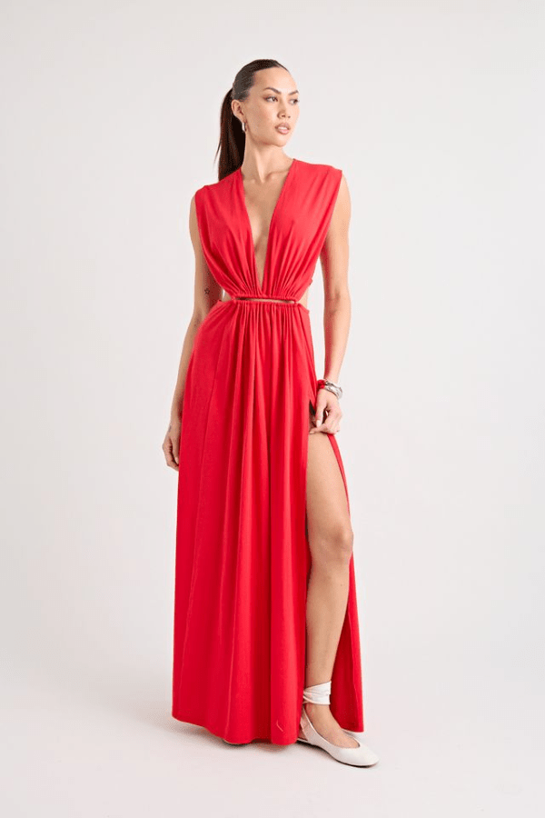 Do For Love Gown Red by Pfeiffer – A trendy low plunge maxi gown with bold hardware and thigh-high split, perfect for turning heads at special occasions.