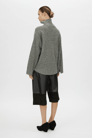 Breccia Knit Sweater Khaki by Camilla and Marc – Trendy oversized merino wool sweater with ribbed details and a modern split back, perfect for casual layering.