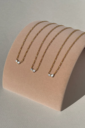 Twin Flame Necklace by Avant Studio in 18k gold plated sterling silver with cubic zirconia and adjustable chain.