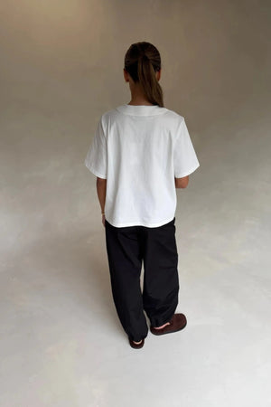 White Olivia High V Neck Relaxed Tee with short sleeves and a loose fit on a plain background.