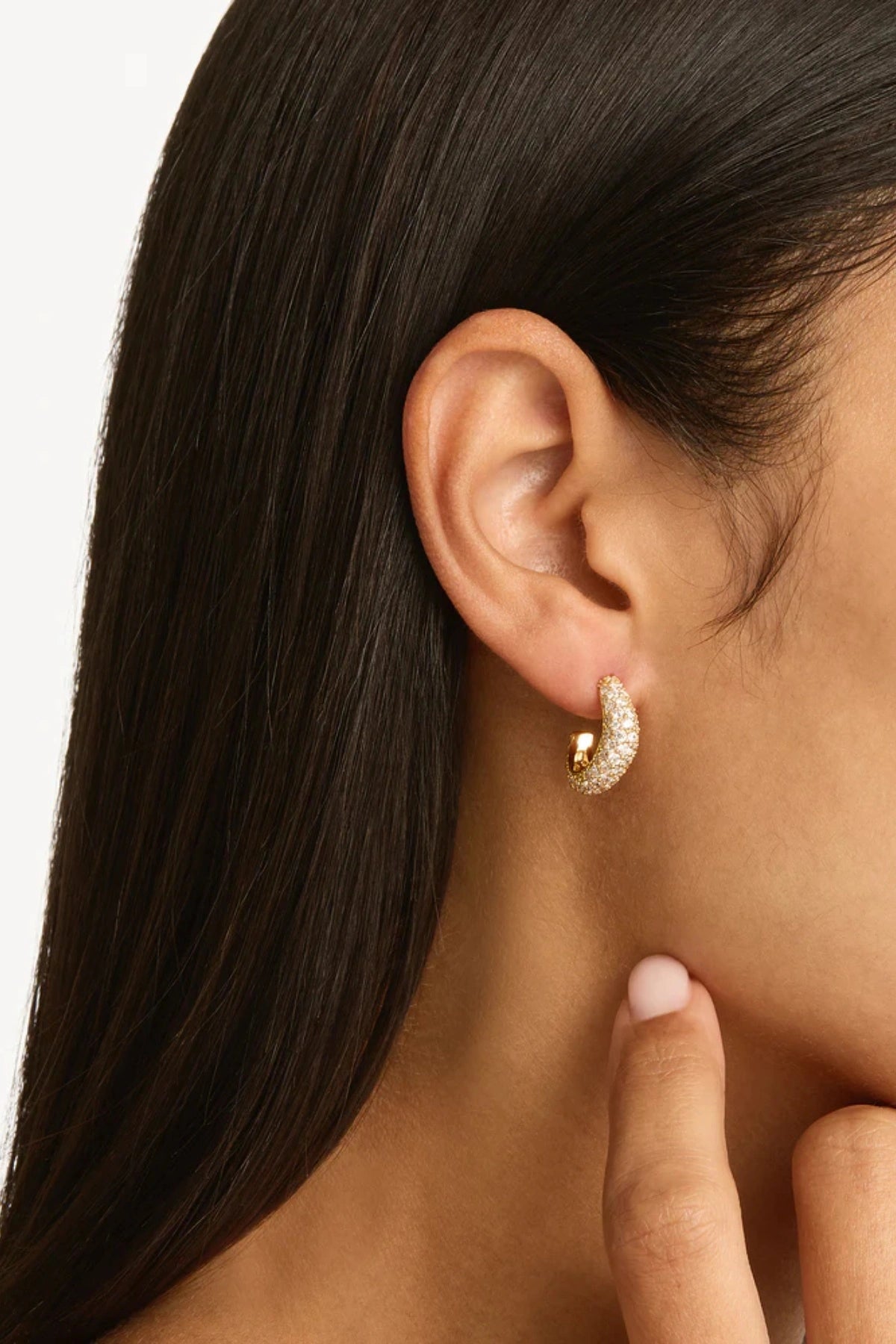 Crystal Wave Hoops by by charlotte — gold vermeil wave-shaped hoops with pavé crystals, perfect for elegant event styling.
