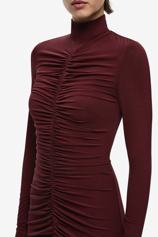 The Gathered Long Sleeve Maxi Dress by MISHA, ruched jersey maxi with mock neck and flared hem for sculpted evening styling.