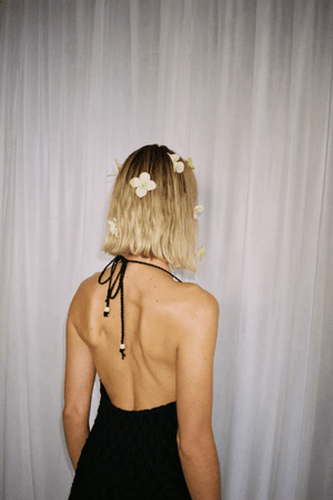 Reis Macrame Maxi Dress Noir by The Wolf Gang – Striking handmade black macrame dress with beaded hem, ideal for festivals or summer soirées.