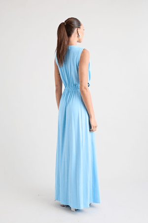 Do For Love Gown Light Blue by Pfeiffer – A trendy, elegant maxi with a deep plunge, thigh-high split, and bold hardware, perfect for special occasions and evening events.