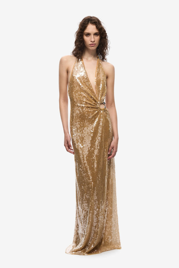 The Devon Sequin Dress by Misha, a mustard gold halter gown with cut-outs and ring detail. Perfect for parties, red carpets, or weddings.