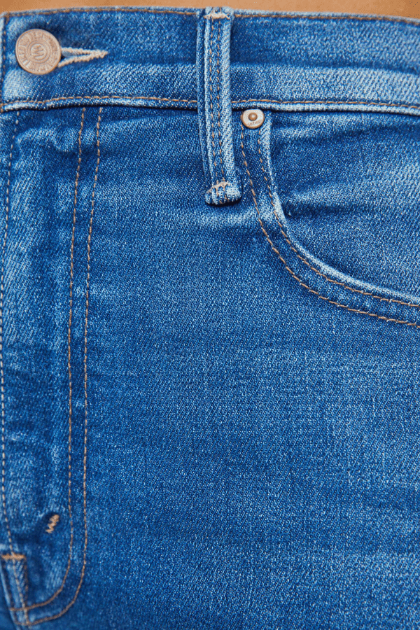 The Rambler Zip Flood Nip In The Bud by MOTHER, trendy high-rise jeans with a wide straight leg and cropped, clean hem. Perfect for a laid-back, polished look in mid-blue with subtle fading and whiskering.