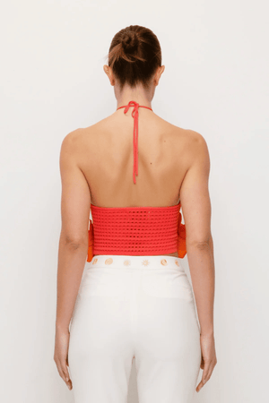 La Monada Knit Top Coral by The Wolf Gang, a bold and trendy piece with asymmetric neckline and cut-outs, crafted from soft ribbed knit, perfect for elevated, fashion-forward looks.