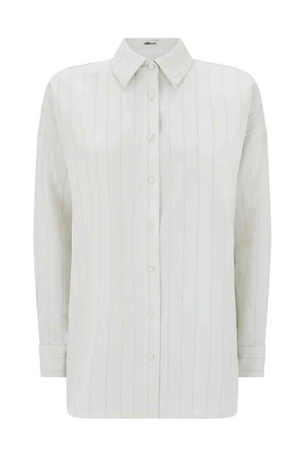 Ultimate Muse Pin Stripe Shirt Oat by Odd Muse — Classic pinstripe button-down with relaxed fit, breathable fabric, and OM embroidery for versatile, polished style.