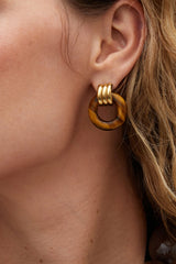 Luma Knot Earrings Gold/Tiger’s Eye by Heaven Mayhem, 18k gold PVD-plated knot earrings with natural Tiger’s Eye stone.