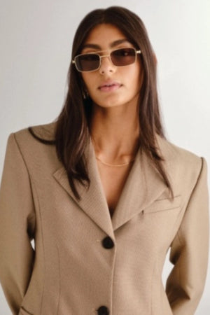 Rocky Gold Sunglasses by Luv Lou – a slim aviator frame with gold finish and brown polarised lenses. Perfect for elevated everyday wear.