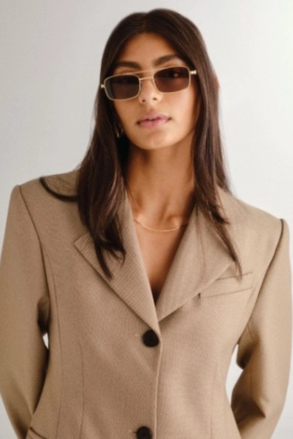 Rocky Gold Sunglasses by Luv Lou – a slim aviator frame with gold finish and brown polarised lenses. Perfect for elevated everyday wear.