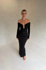 Black Haley off-shoulder midi dress with fitted bodice and flowy skirt, featuring short sleeves and a subtle slit.