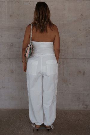 Bella Halter Tank White by Sneaky Link – Soft cotton-spandex blend with a deep scoop neckline, open back, and supportive halter design. Perfect for layering or solo wear.