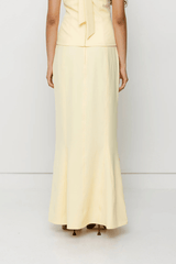 Inka Maxi Skirt Butter by The Wolf Gang, a flared godet midi with custom embroidery. Perfect for standout sets or sunny solo moments.
