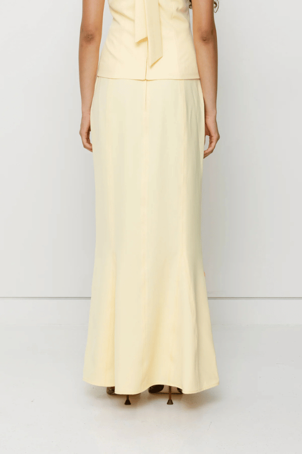 Inka Maxi Skirt Butter by The Wolf Gang, a flared godet midi with custom embroidery. Perfect for standout sets or sunny solo moments.