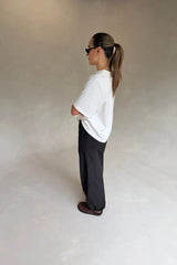 White Olivia High V Neck Relaxed Tee with short sleeves and a loose fit on a plain background.