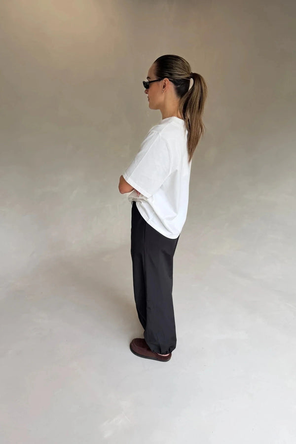 White Olivia High V Neck Relaxed Tee with short sleeves and a loose fit on a plain background.