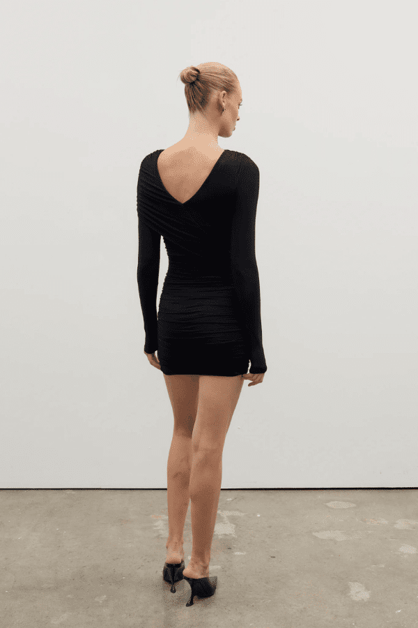 Kai Mini Dress Shadow by Bayse – Trendy ruched mini with asymmetric draped bodice, high boat neck, and bold deep V-back. Perfect for chic nights out and special events.