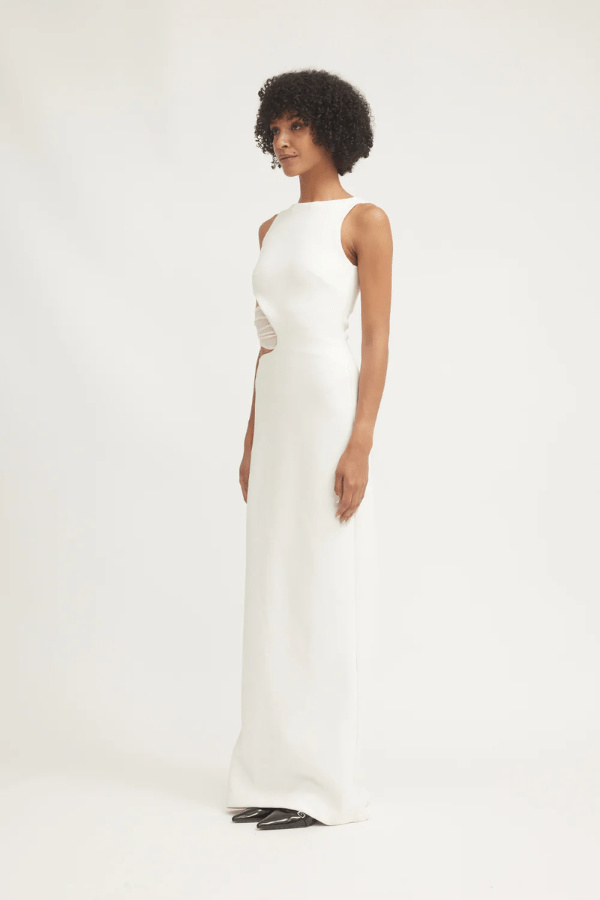 Valentina Dress Ivory by Tojhà – A sophisticated maxi in ultra-soft crepe with boat neckline, curved cut-out, and mesh detail, perfect for elegant evening occasions.