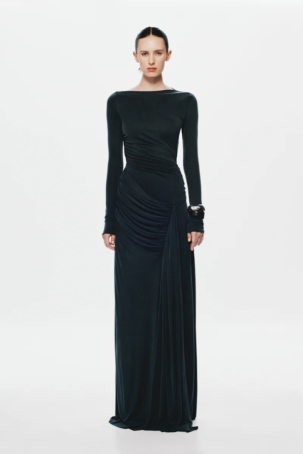 The 'Glacier' Long Sleeve Dress Black by MISHA, full-length black maxi with sculptural draping, high boat neckline, asymmetrical pleats, dry clean only.
