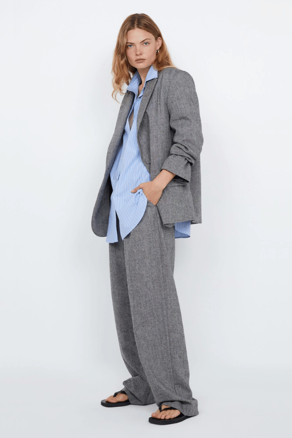 Brinley Blazer Salt & Pepper Weave by Bec + Bridge – Tailored single-breasted blazer in heavy wool blend with self-covered buttons, shoulder pads, boxy fit, and back vent. Fully lined.