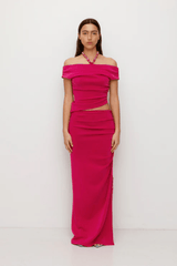 Flor Top Magenta by The Wolf Gang — an elegant event-ready top with asymmetric neckline, soft jersey fabric, and delicate beaded strap. True to size, perfect for casual or bold looks.