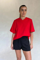 Red Olivia High V Neck Relaxed Tee with short sleeves and a loose fit on a plain background.