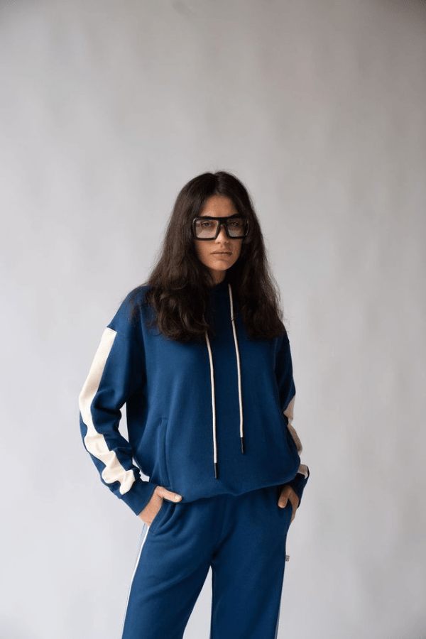 1984 Hoodie Estate Blue by Araminta James, soft cotton brushed fleece with contrast trim and velvet graphic, relaxed fit perfect for casual cool days.