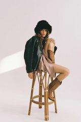 Snuggle Bucket Black by Lack of Color, a faux fur bucket hat with turnback brim and silky lining. Perfect for cozy winter styling.