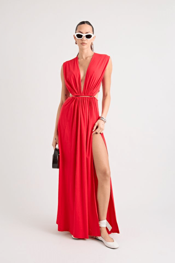Do For Love Gown Red by Pfeiffer – A trendy low plunge maxi gown with bold hardware and thigh-high split, perfect for turning heads at special occasions.