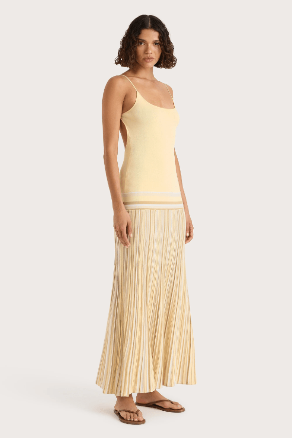 Citara Maxi Dress Butter Stripe by Faithfull the Brand – Trendy ribbed knit maxi with adjustable straps and backless tie, perfect for effortless summer elegance and beach days.