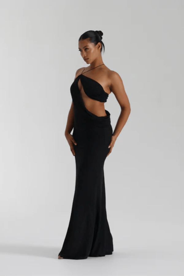 Elissa Dress Black by Natalie Rolt – A glamorous stretch-knit maxi with metallic threads, asymmetrical cutaway, and adjustable fit, perfect for elegant evenings and special occasions.