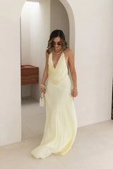Jaz Hand V-Neck Maxi Dress in Butter by Sneaky Link, a flowing one-shoulder silhouette in soft yellow. Perfect for summer events or weddings.
