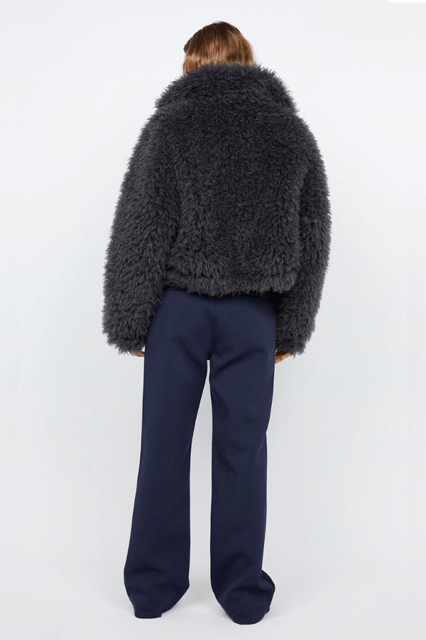 Argo Jacket Charcoal by Bec + Bridge – A chic charcoal faux fur bomber with wide collar, relaxed fit, front hook closure, and low waist finish. Fully lined. Dry clean only.